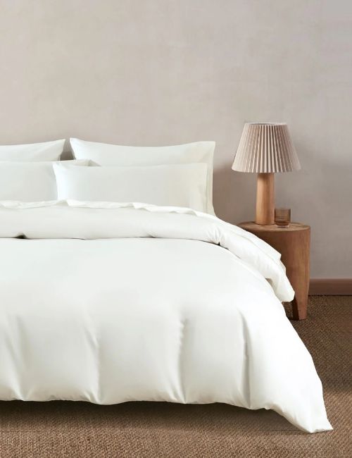 White Egyptian cotton bedding set on a minimalist bed, reflecting clean luxury and soft texture.